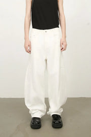 White wide leg trousers with sculpted pocket details and a relaxed fit.