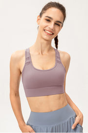 Mauve sports bra with mesh insets on straps and a scoop neckline.