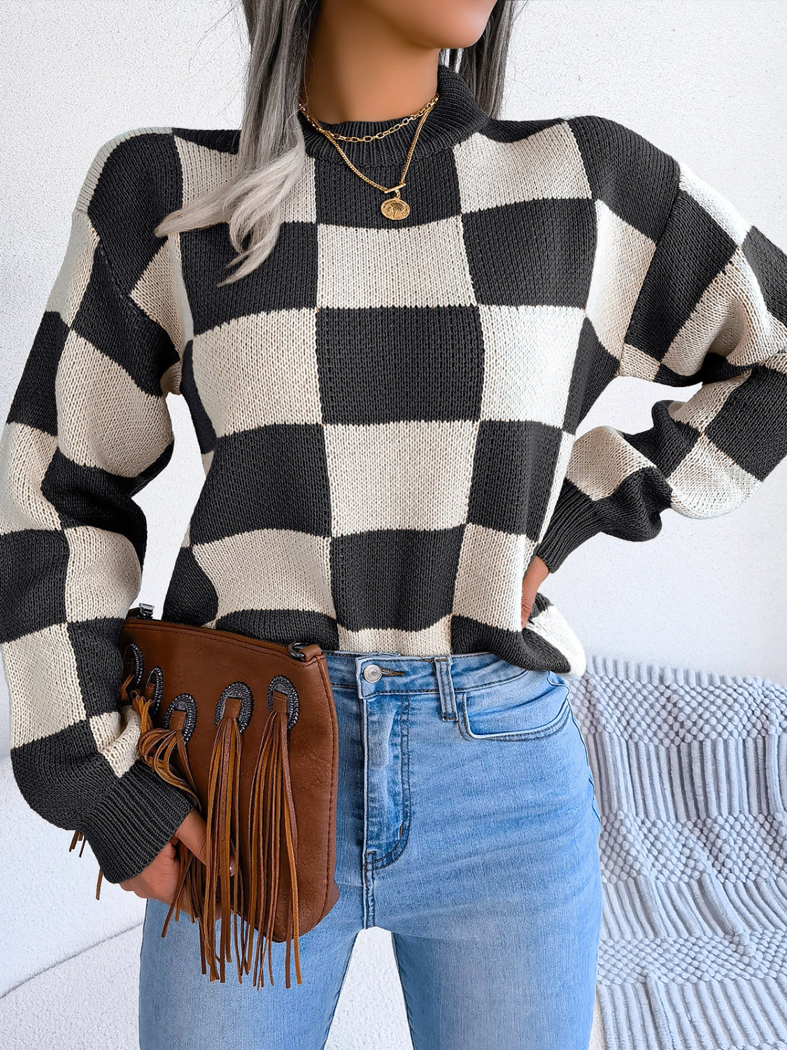 Checkerboard knit mock neck pullover sweater in black and cream acrylic.