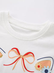 White cotton baby tee with embroidered cat ears, bow, and floral details.