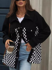 Black button-up jacket with checkerboard panels and silver buttons.