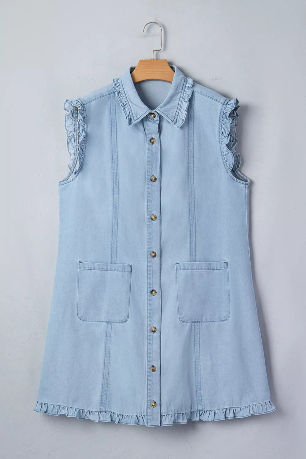 Light blue denim shift dress with ruffled collar, sleeves, and hem, button-down front, and pockets.