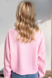 Pink ribbed knit sweater with crew neck and long sleeves, casual style.