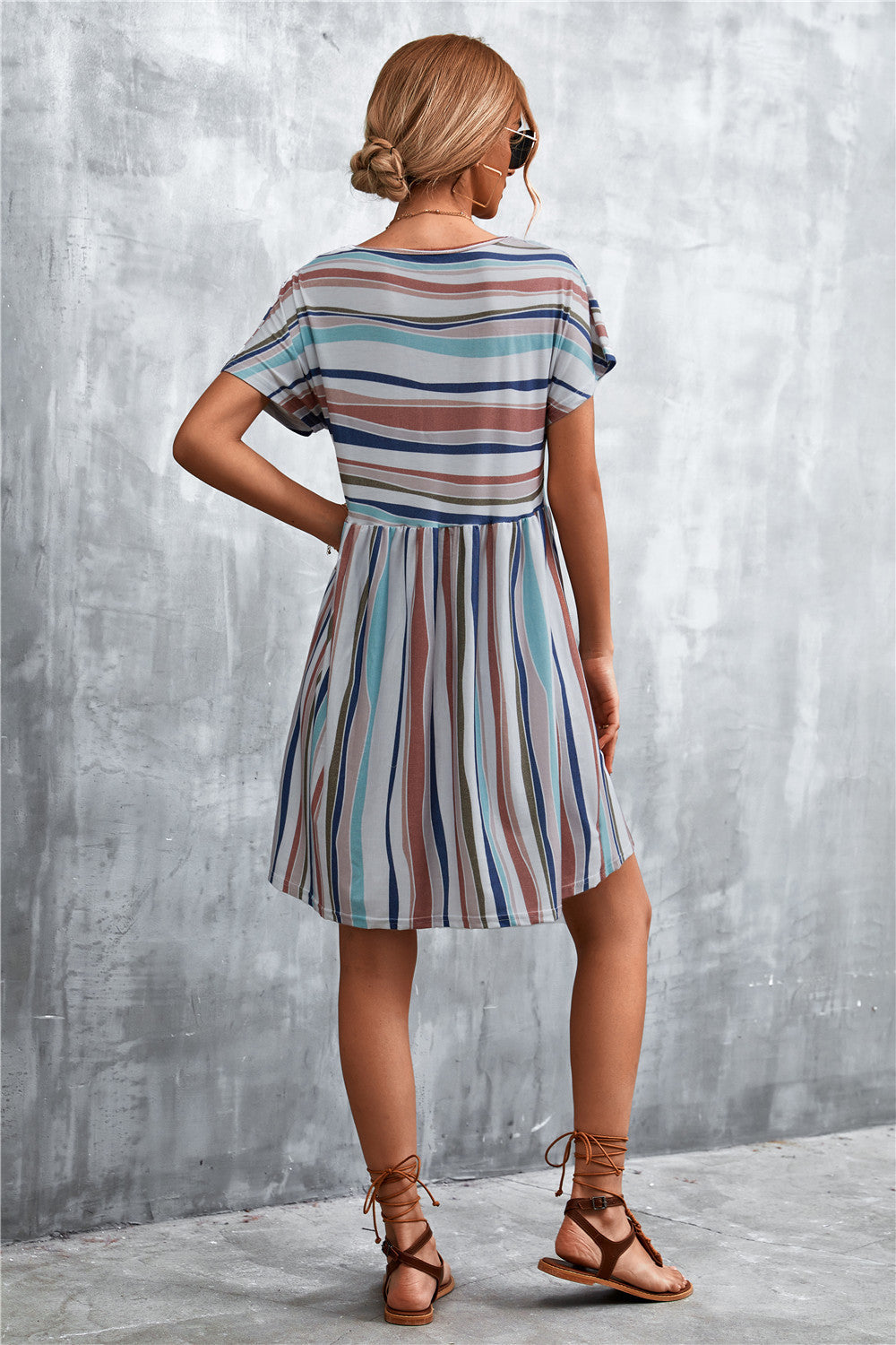 Striped trapeze dress with horizontal yoke and vertical skirt stripes in multi-color.