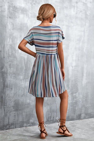 Striped trapeze dress with horizontal yoke and vertical skirt stripes in multi-color.