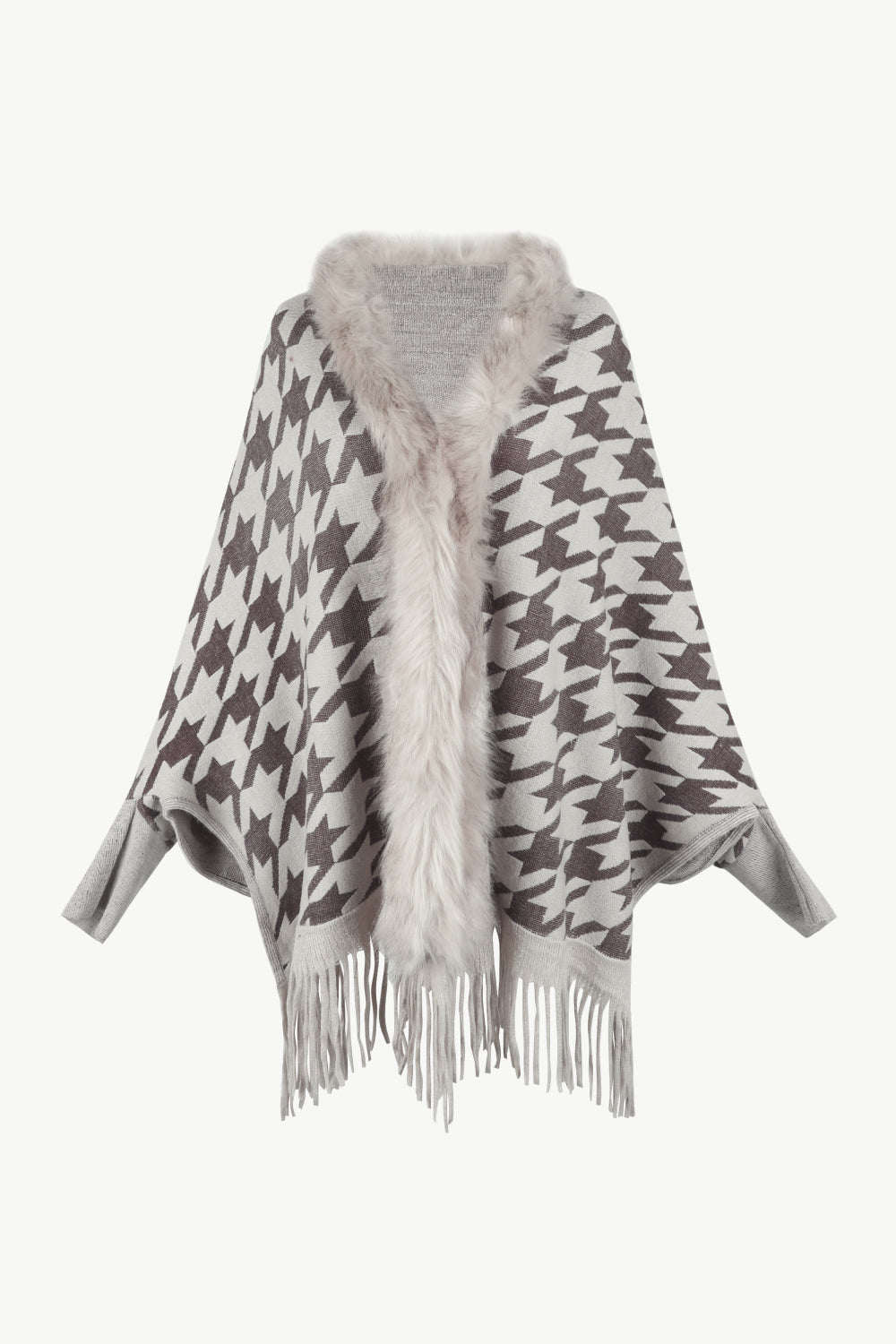 Houndstooth knit poncho with faux fur collar and fringe hem.