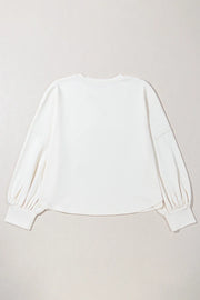 White relaxed fit sweatshirt with gathered balloon sleeves and ribbed cuffs.