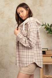 Cozy plaid shacket in Camel with sherpa hood and drawstring detail.