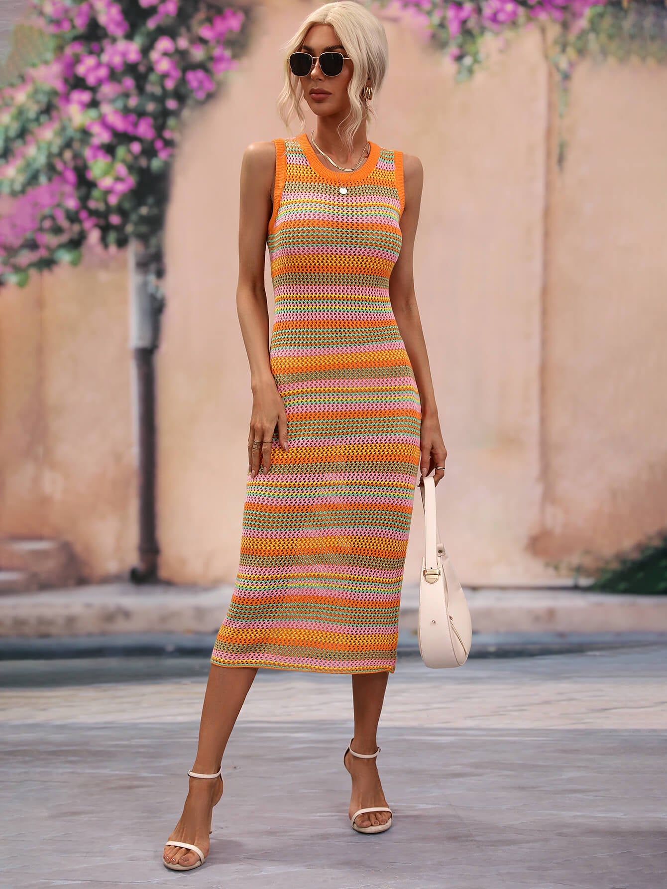 Striped knit sleeveless midi dress in orange, pink, and green with a round neckline.