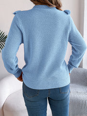 Light blue textured knit sweater with ruffle yoke detail and mock neck.