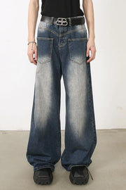Faded wash palazzo jeans in medium blue denim with a wide leg and distressed details.