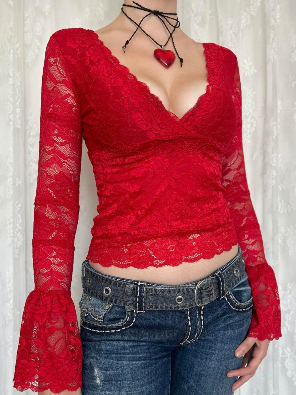 Red lace surplice blouse with scalloped trim and bell sleeves.