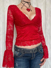 Red lace surplice blouse with scalloped trim and bell sleeves.