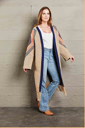 Khaki long cardigan with geometric trim, navy blue trim, and fringed hemline.