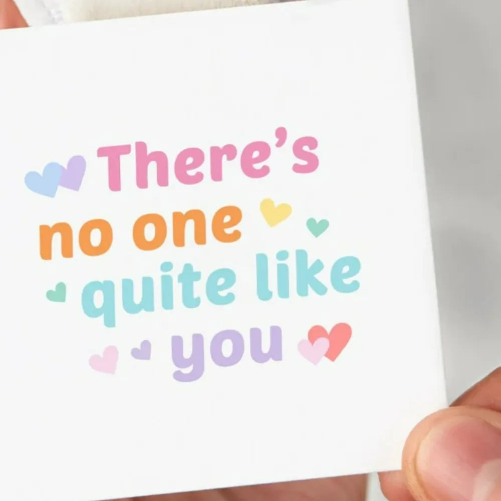 Pixel Heart Rainbow Ring with "There's no one quite like you" text and heart accents.