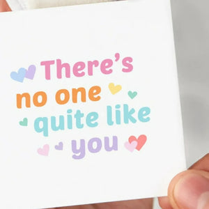 Pixel Heart Rainbow Ring with "There's no one quite like you" text and heart accents.