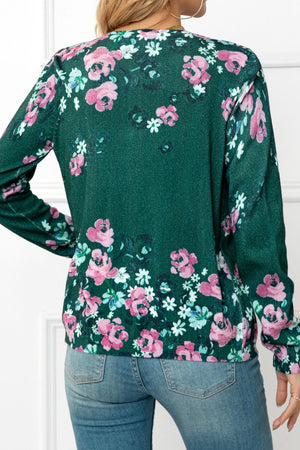 Forest green crewneck cardigan with a pink and white floral botanical print.