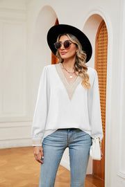 White V-neck blouson top with embroidered trim on neckline and cuffs.