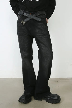 Faded black denim flare jeans with a distressed wash and a black belt.