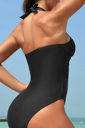Black halter one-piece swimsuit with mesh insets and crossover detail
