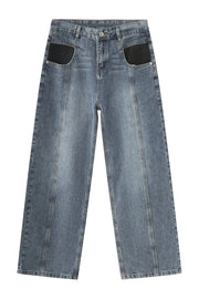 Panel seam denim trousers in medium wash with black pocket details and wide leg.
