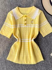 Yellow cable knit polo shirt with white stripes, buttoned placket, and decorative pin.