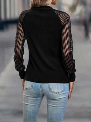 Black ribbed knit sweater with sheer stripe sleeves