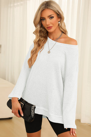 White waffle knit oversized top with slit hem, off-the-shoulder neckline, and long sleeves.
