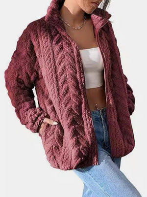 Burgundy textured chevron fleece zip jacket with a stand-up collar and pockets.