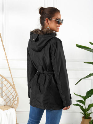 Black belted utility parka with faux fur hood trim and a cinched waist.