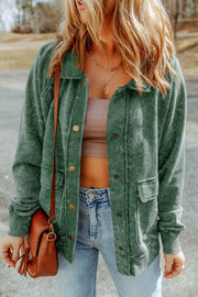Green washed cotton utility jacket with button front, chest pockets and long sleeves.