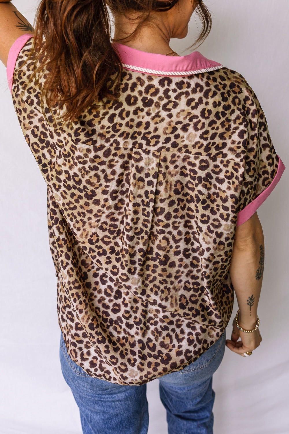 Print short sleeve shirt with animal print, pink collar and cuffs, button up style.