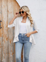 White eyelet cascade cardigan with open front and 3/4 sleeves, styled with a tank top and jeans.