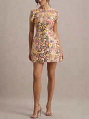 Floral sequin mini dress with short sleeves and a round neckline.