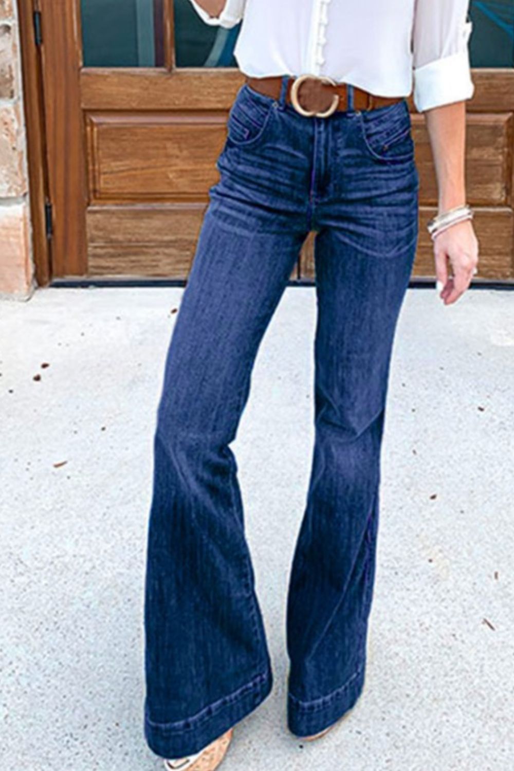High-waisted dark wash denim bell bottom jeans with a buttoned fly.