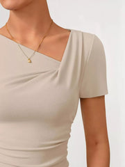 Beige asymmetrical maternity t-shirt with short sleeves and a draped neckline.