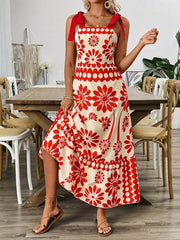 Charming floral tie-shoulder midi dress in red and cream with a-line cut and ruffled hem.