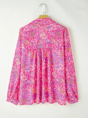 Hot pink graphic print blouse with gathered waist and mesh sleeves.