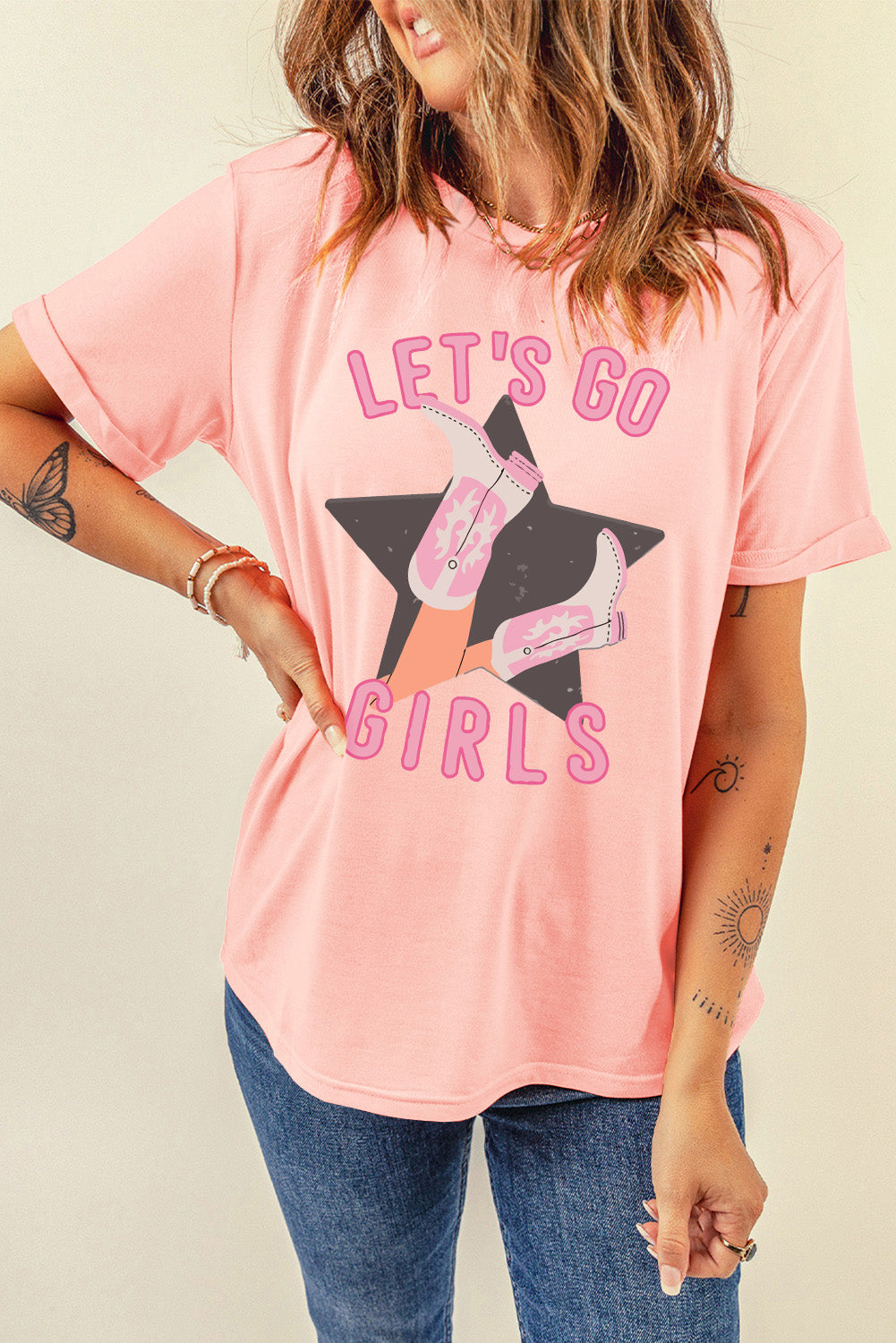Pink graphic tee with rolled sleeves and a western boots and star design.