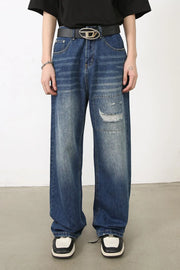 Baggy patchwork denim jeans in medium vintage wash with distressed details.