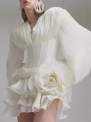 White ruffle mini dress with balloon sleeves, V-neck, corset waist, and large floral applique.