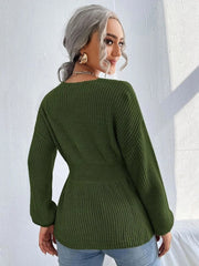 Green peplum knit sweater with scallop neckline and long sleeves.