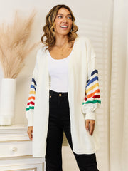 White knit open-front cardigan with rainbow striped sleeves