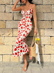 Women's white midi dress with red floral print, spaghetti straps, and tie-front neckline.