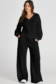 Black V-neck loungewear set with wide-leg pants featuring seam detail.