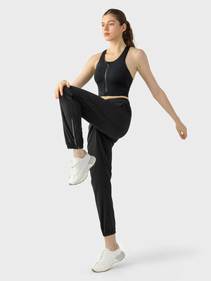 Black zip-front racerback sports bra with a cropped fit.