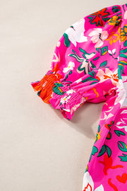 Hot pink floral print tunic with gathered sleeves and orange cuff detail.