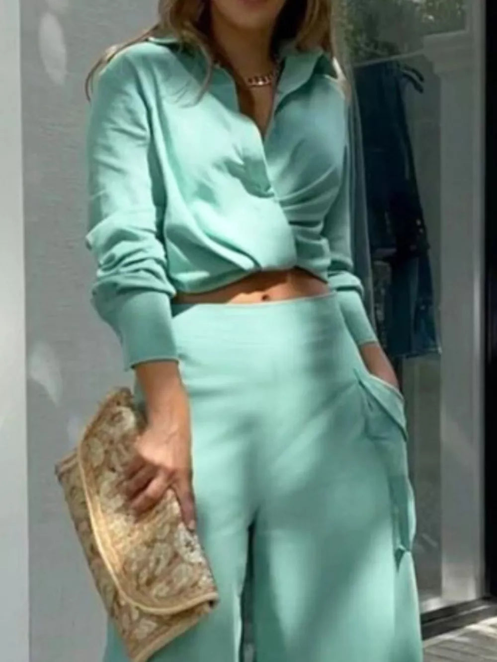 Teal two-piece set with pocketed pants and twisted crop top, polyester, women's outfit