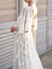 White lace flutter sleeve v-neck dress with floral embroidery and open back.