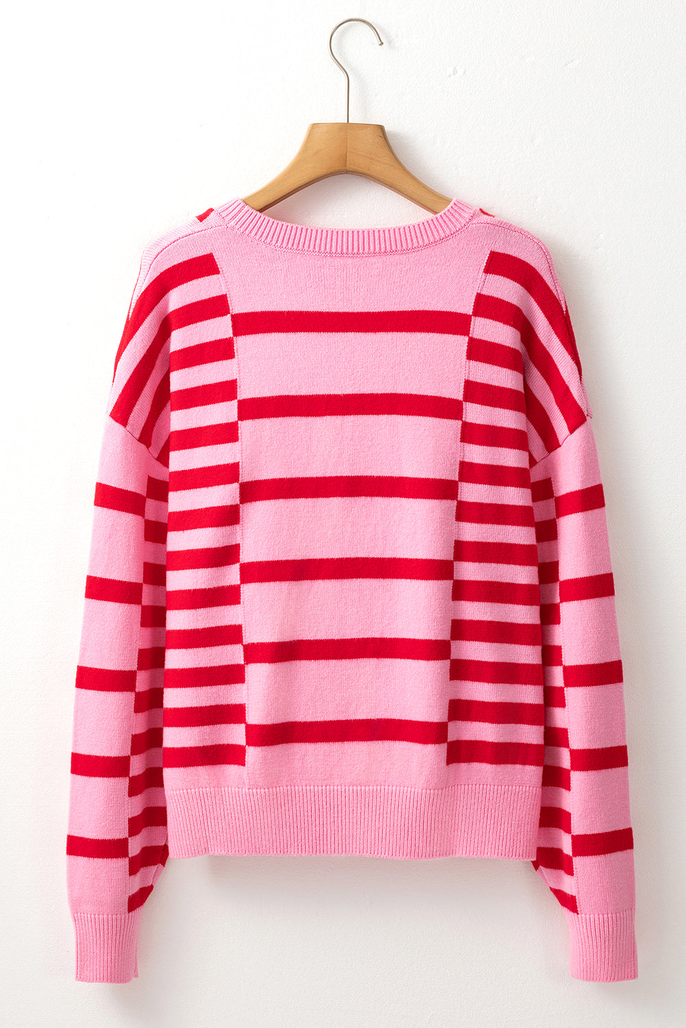 Colorblock stripe knit sweater with balloon sleeves in hot pink and red.